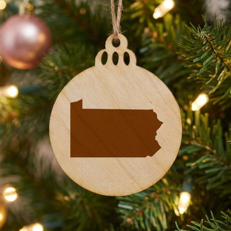 Pennsylvania round wood Christmas ornament with the full state shape engraved