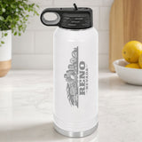 White 32 oz insulated water bottle laser engraved with the Reno, Nevada skyline running up the side, standing on a kitchen counter