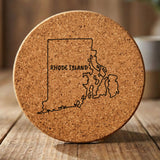 Rhode Island round cork coaster engraved with the state outline and RHODE ISLAND in hand-drawn brush lettering