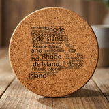 Rhode Island round cork coaster engraved with a word cloud of repeating Rhode Island text