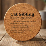 Round cork coaster laser engraved with the Cat Sibling definition