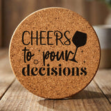 Round cork coaster laser engraved with "Cheers to Pour Decisions"