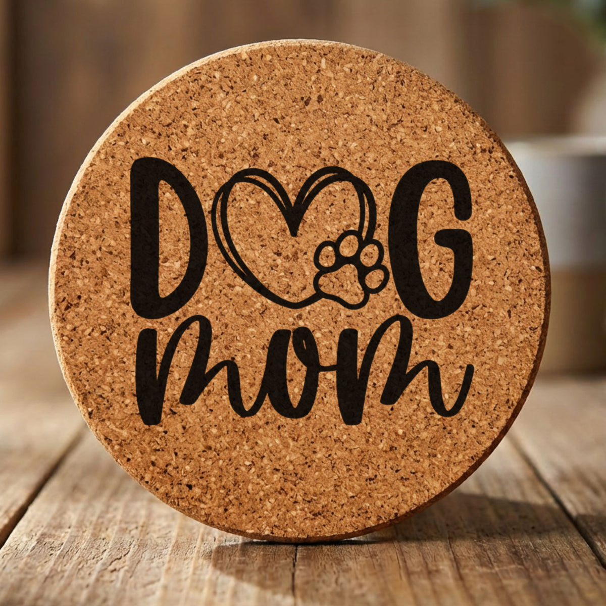 Round cork coaster laser engraved with a hand drawn Dog Mom heart and paw design