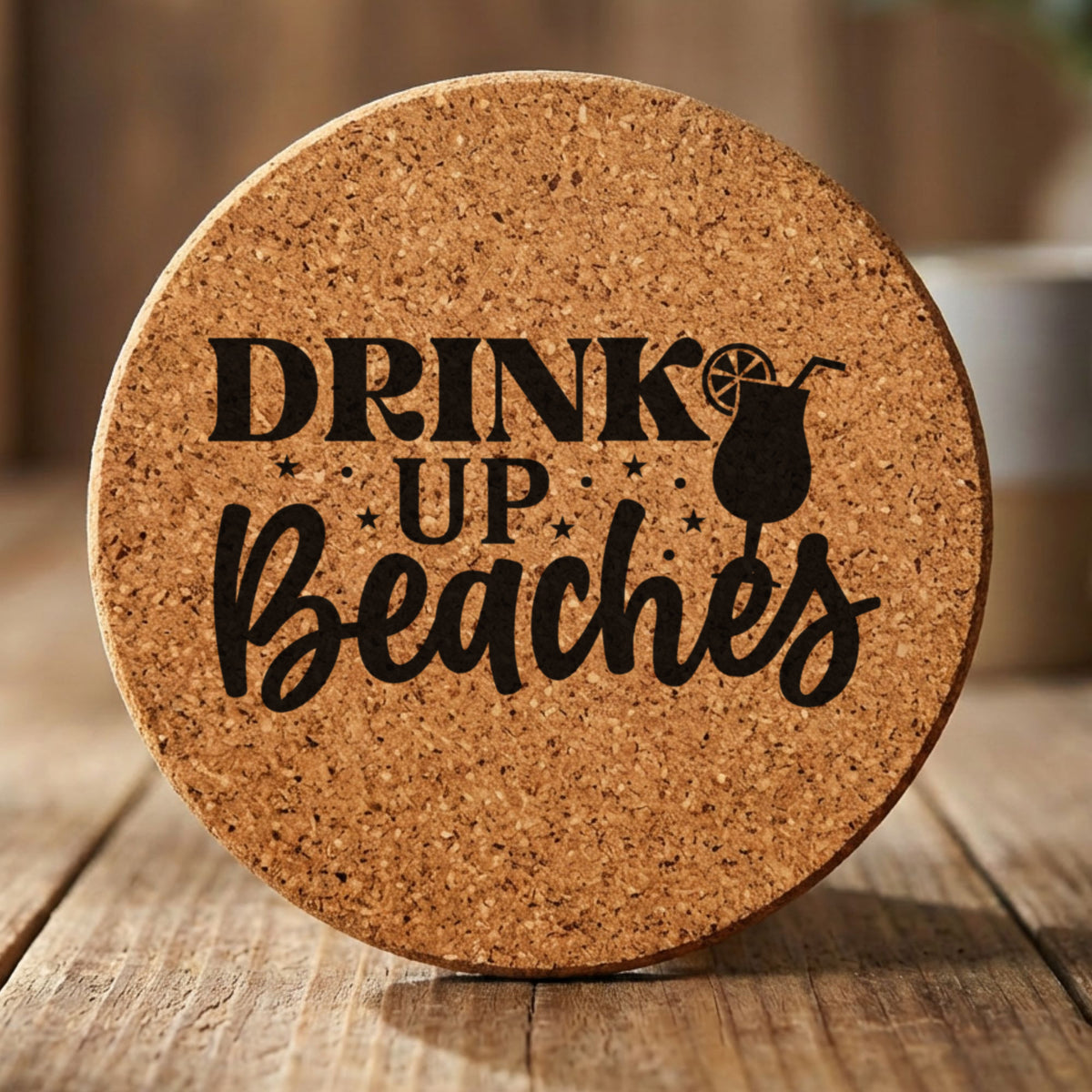 Round cork coaster laser engraved with "Drink Up Beaches"