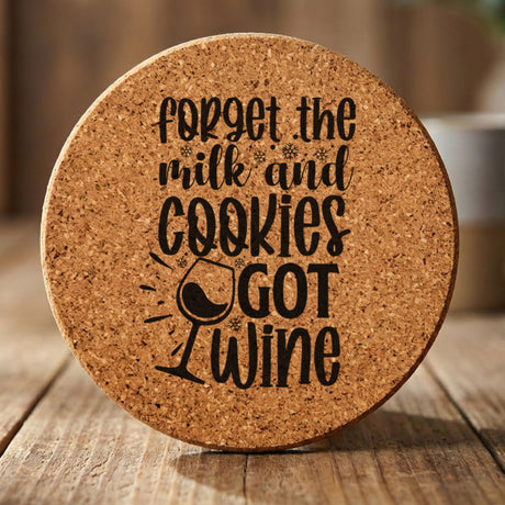 Round cork coaster laser engraved with "Forget the Milk and Cookies, I've Got Wine"