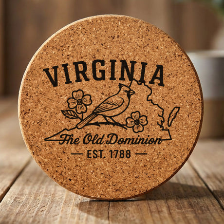 Virginia round cork coaster engraved with the state outline, a cardinal and dogwood blossoms, "The Old Dominion"