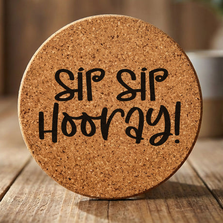 Round cork coaster laser engraved with "Sip Sip Hooray"