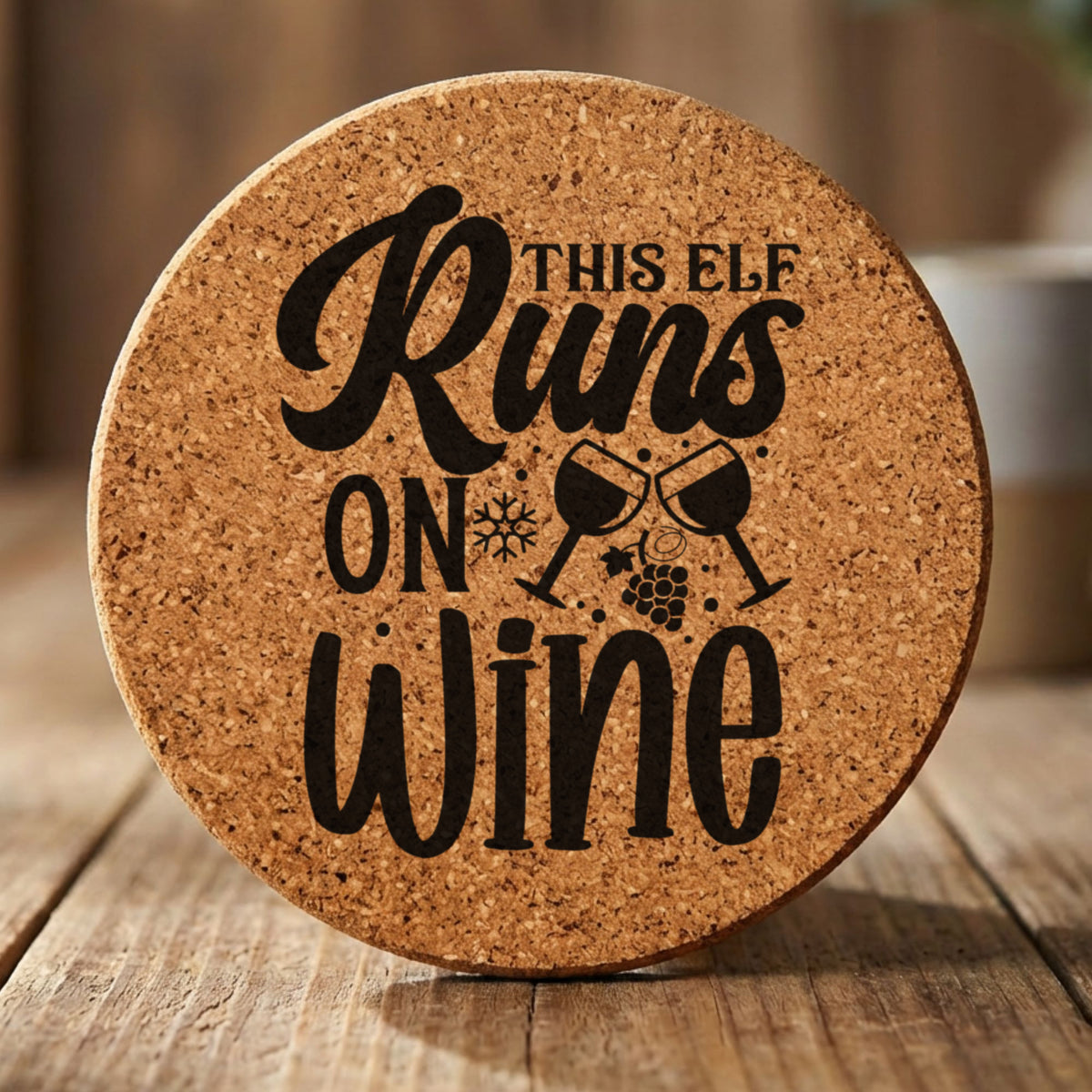 Round cork coaster laser engraved with "This Elf Runs on Wine"