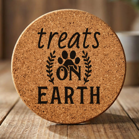 Round cork coaster laser engraved with "Treats on Earth"