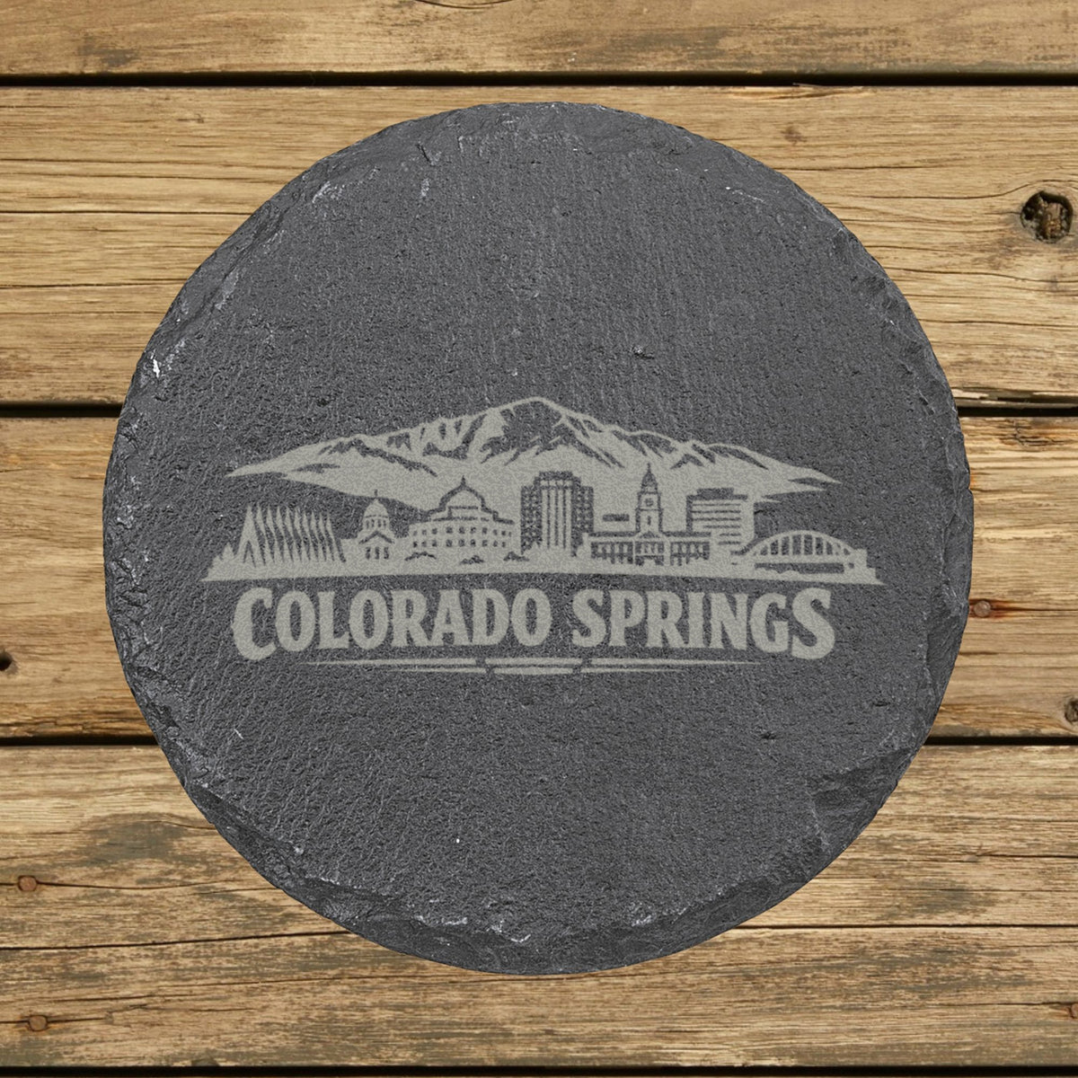 Round slate coaster laser engraved with the Colorado Springs, Colorado skyline