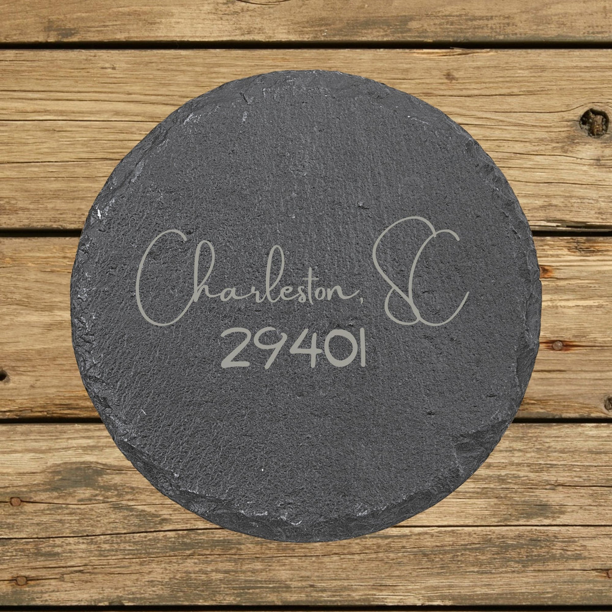 Round slate coaster laser engraved with a custom zip code design