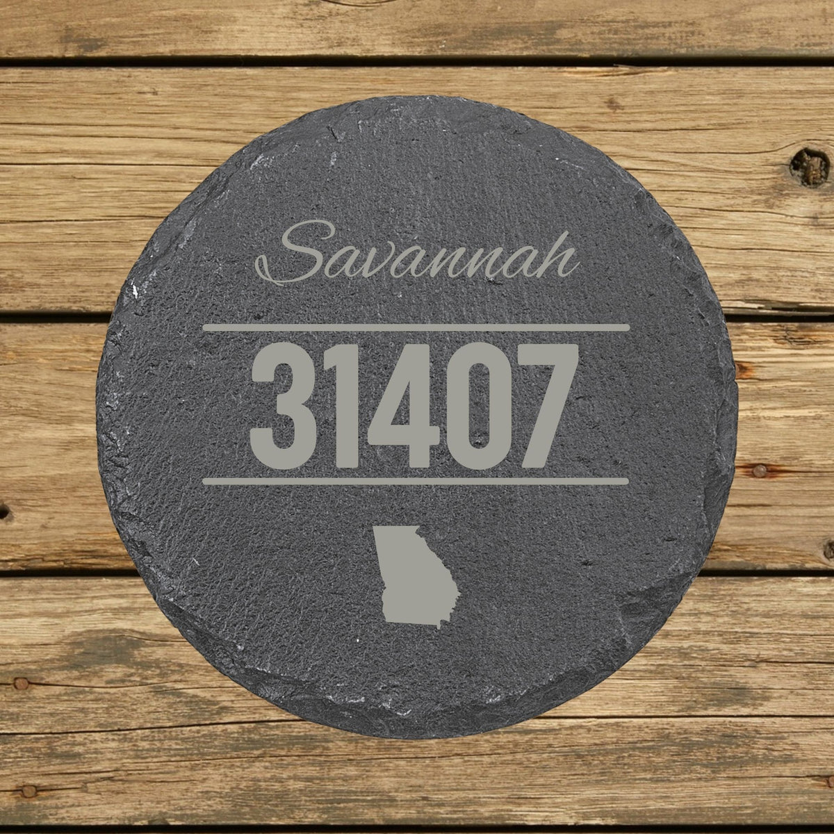 Round slate coaster laser engraved with a custom zip code design