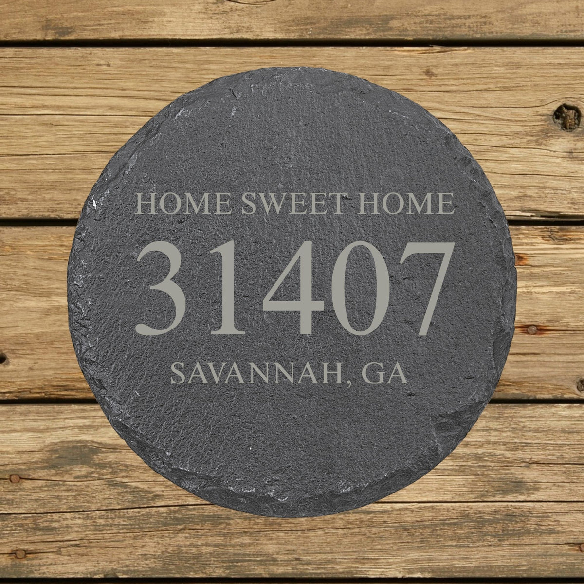 Round slate coaster laser engraved with a custom zip code design