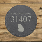 Round slate coaster laser engraved with a custom zip code design