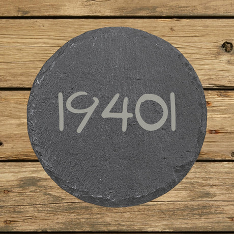 Round slate coaster laser engraved with a custom zip code design