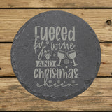 Round slate coaster laser engraved with "Fueled by Wine and Christmas Cheer"