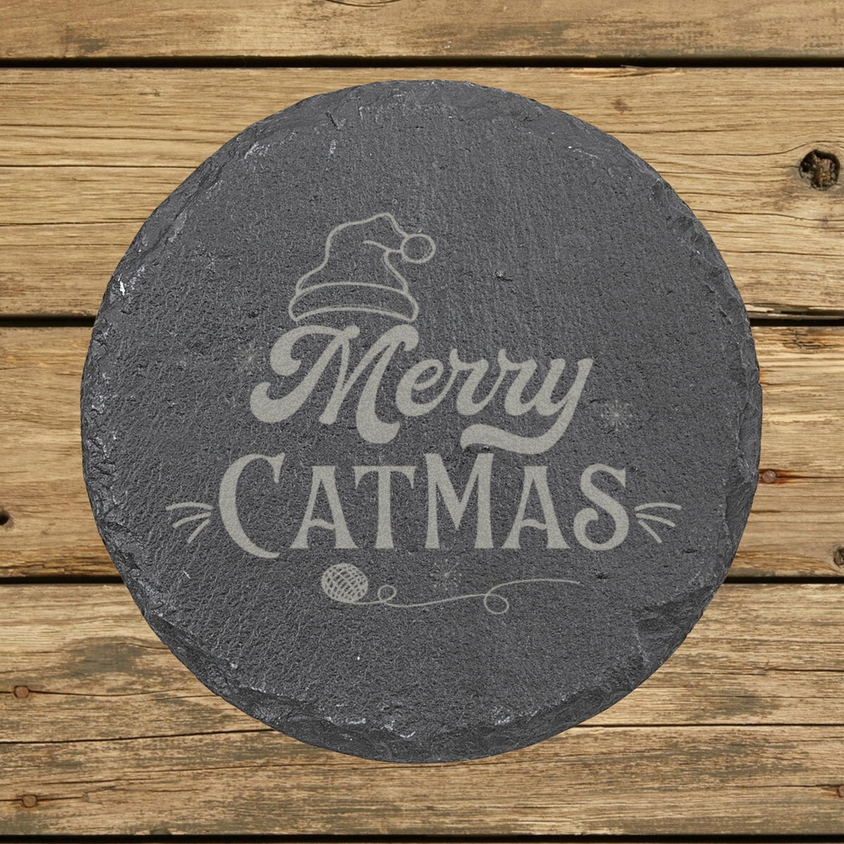 Round slate coaster laser engraved with "Merry Catmas"