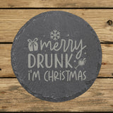 Round slate coaster laser engraved with "Merry Drunk I'm Christmas"
