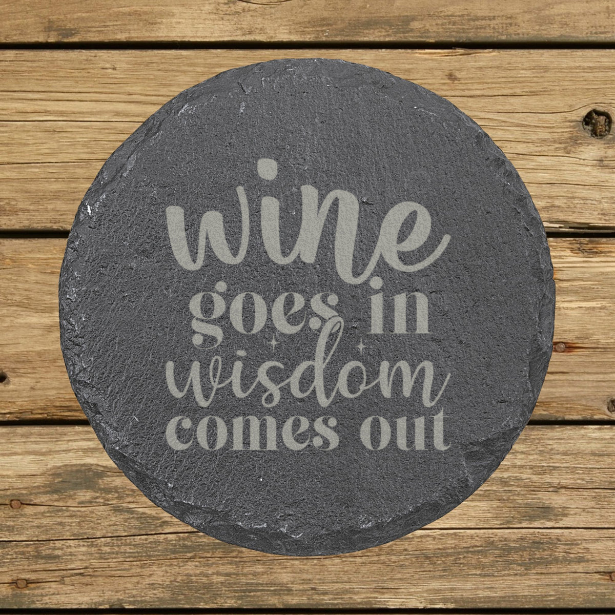 Round slate coaster laser engraved with "Wine Goes In, Wisdom Comes Out"