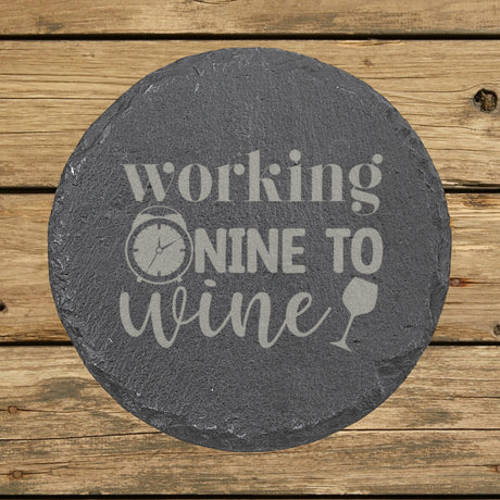 Round slate coaster laser engraved with "Working Nine to Wine"