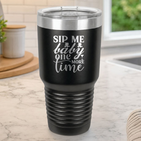 Black 30 oz tumbler laser engraved with "Sip Me Baby One More Time", on a kitchen counter