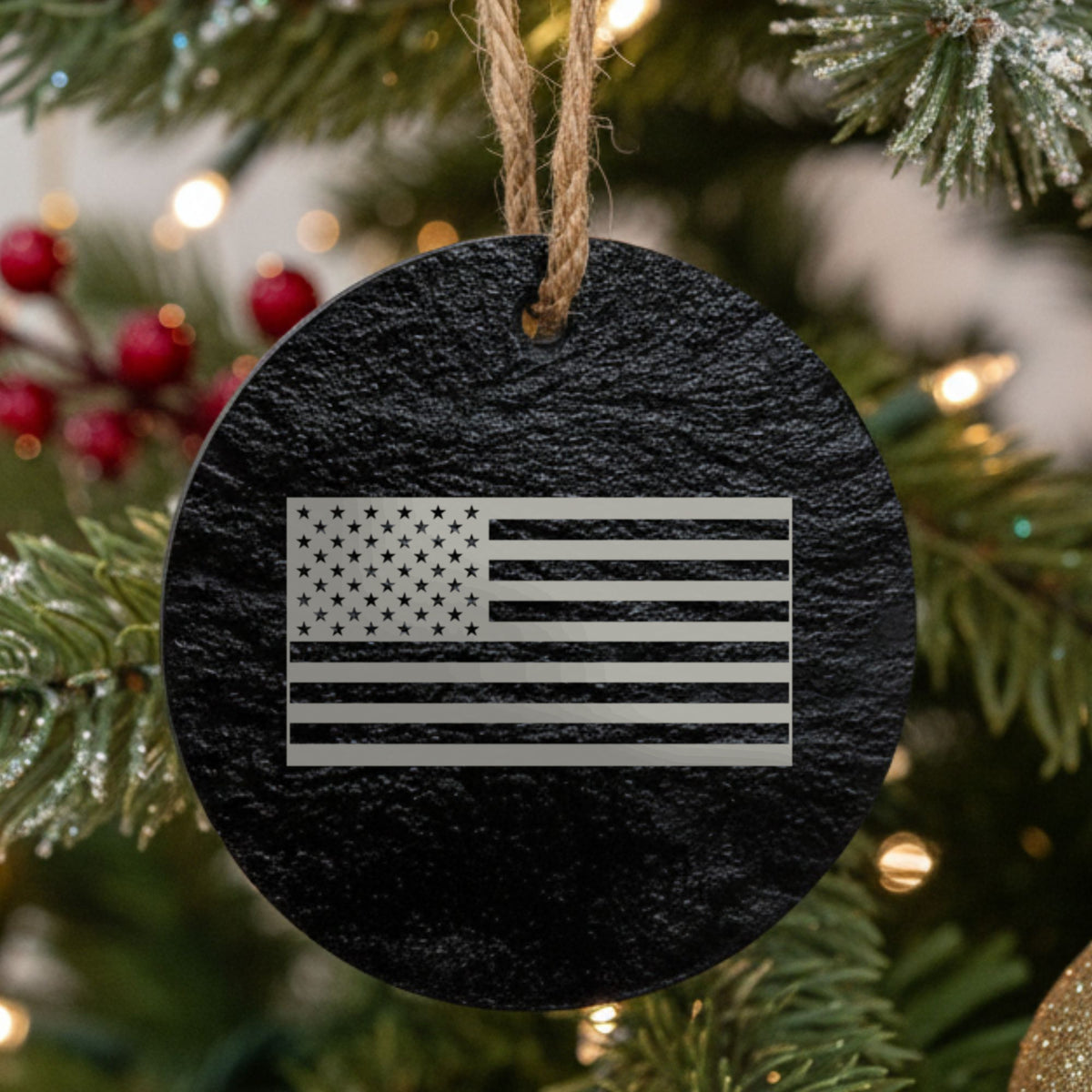 Round black slate Christmas ornament laser engraved with an American flag, classic design