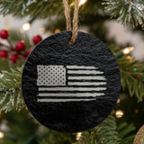 Round black slate Christmas ornament laser engraved with an American flag, distressed design