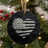 Round black slate Christmas ornament laser engraved with an American flag, heart design