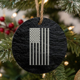 Round black slate Christmas ornament laser engraved with an American flag, vertical design