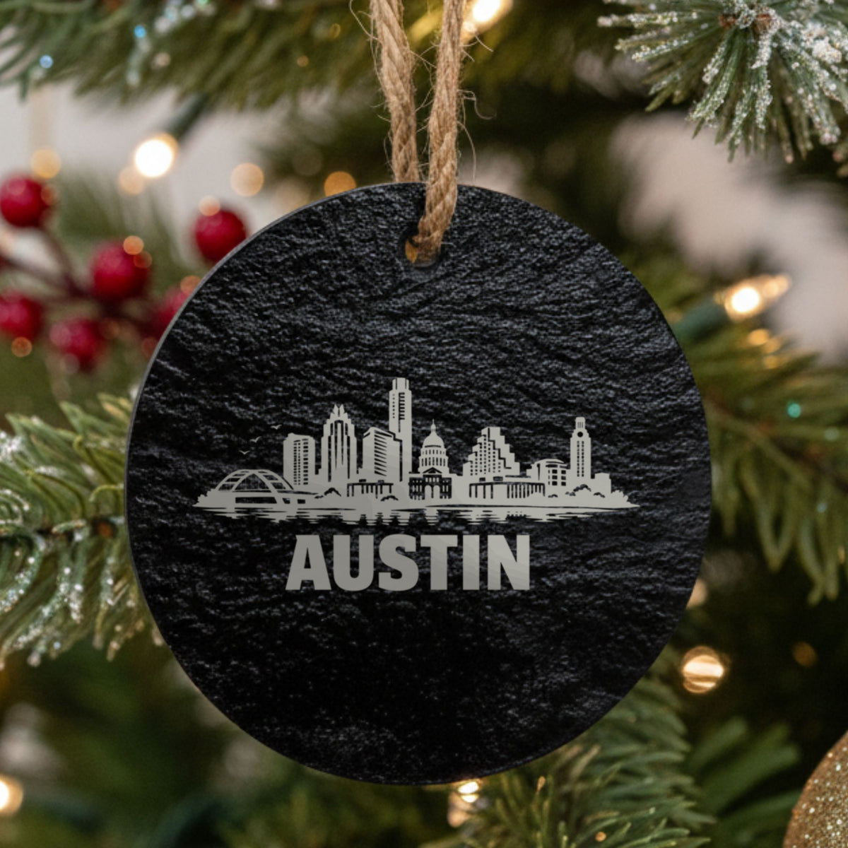 Austin, Texas skyline engraved on a round slate Christmas ornament