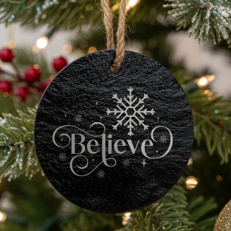 Slate Christmas Ornament hanging on a tree that says Believe