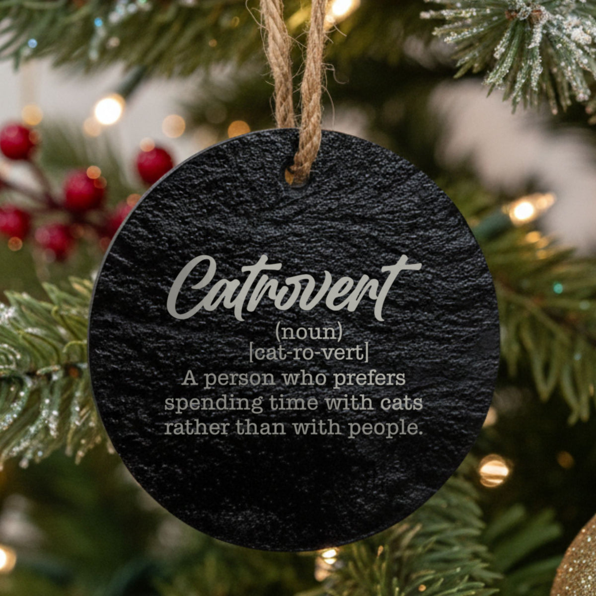 Round black slate Christmas ornament laser engraved in white with the Catrovert dictionary definition