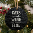 Round black slate Christmas ornament, laser engraved in white with "Cats and Wine Make Everything Fine"