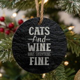 Round black slate Christmas ornament, laser engraved in white with "Cats and Wine Make Everything Fine"