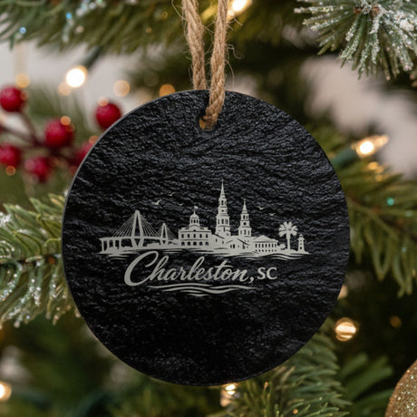 Charleston, South Carolina skyline engraved on a round slate Christmas ornament