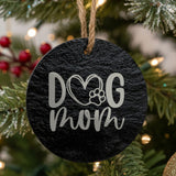 Round black slate Christmas ornament laser engraved in white with a hand drawn Dog Mom heart and paw design