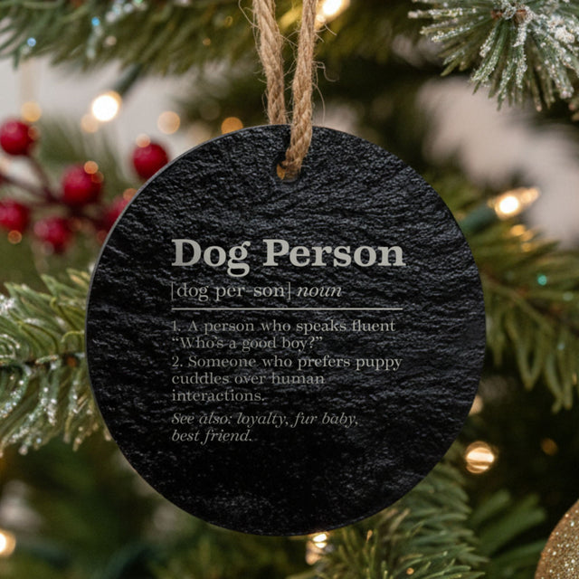 Round black slate Christmas ornament laser engraved in white with the Dog Person dictionary definition