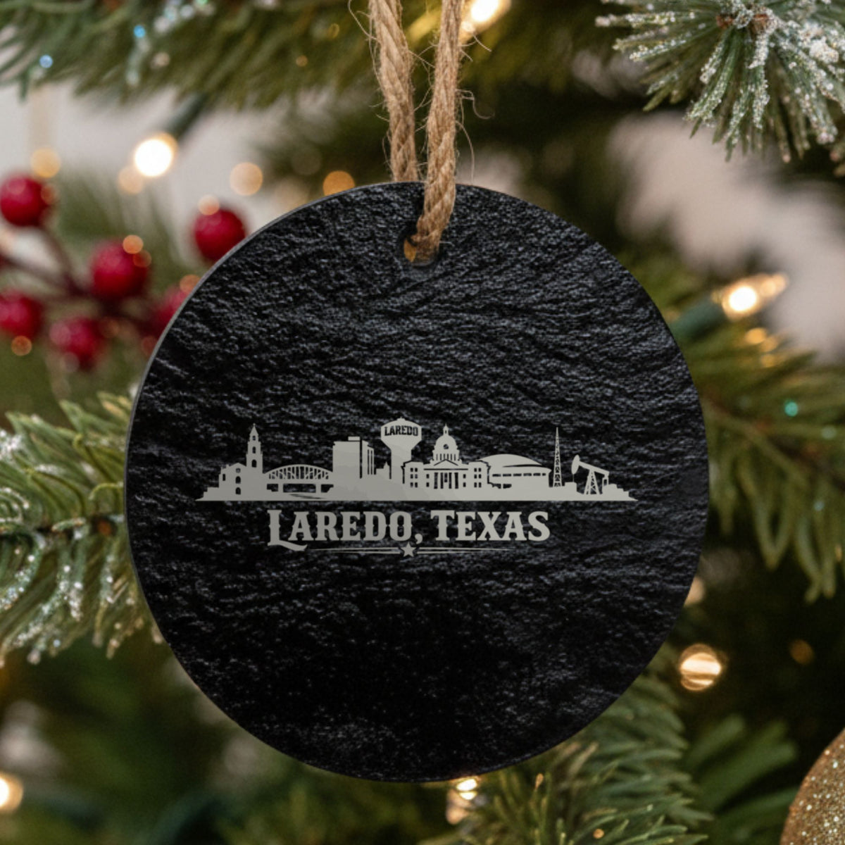 Laredo, Texas skyline engraved on a round slate Christmas ornament
