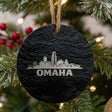 Omaha, Nebraska skyline engraved on a round slate Christmas ornament