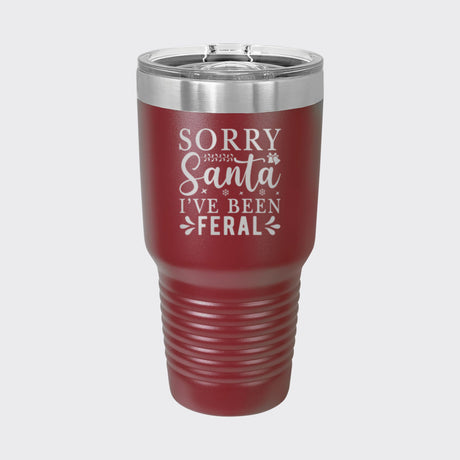 Maroon 30 oz tumbler laser engraved with "Sorry Santa, I've Been Feral"