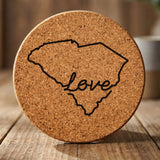 South Carolina round cork coaster engraved with a hand-drawn state outline and love in cursive