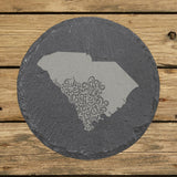 South Carolina round slate coaster engraved with the state shape in ornate floral scrollwork