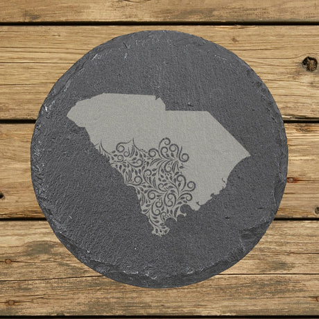 South Carolina round slate coaster engraved with the state shape in ornate floral scrollwork
