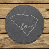 South Carolina round slate coaster engraved with a hand-drawn state outline and love in cursive