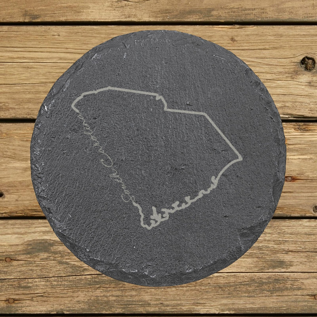 South Carolina round slate coaster engraved with the state outline and South Carolina in script lettering