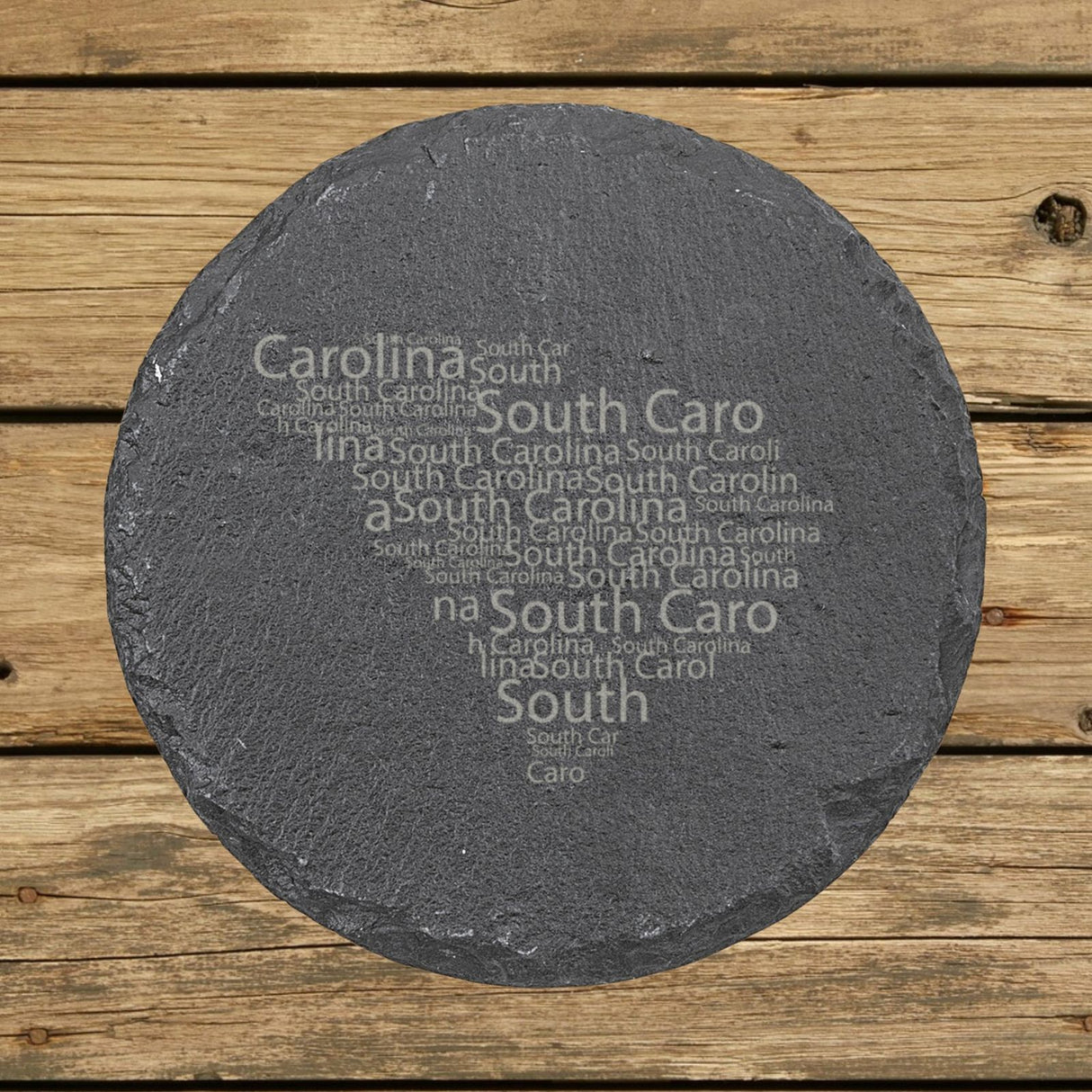 South Carolina round slate coaster engraved with a word cloud of repeating South Carolina text