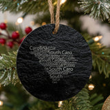South Carolina round slate Christmas ornament engraved with a word cloud of repeating South Carolina text