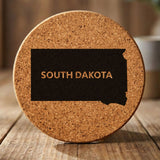 South Dakota round cork coaster engraved with the state shape and SOUTH DAKOTA in bold lettering