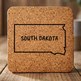 South Dakota square cork coaster engraved with the state outline and SOUTH DAKOTA in hand-drawn brush lettering