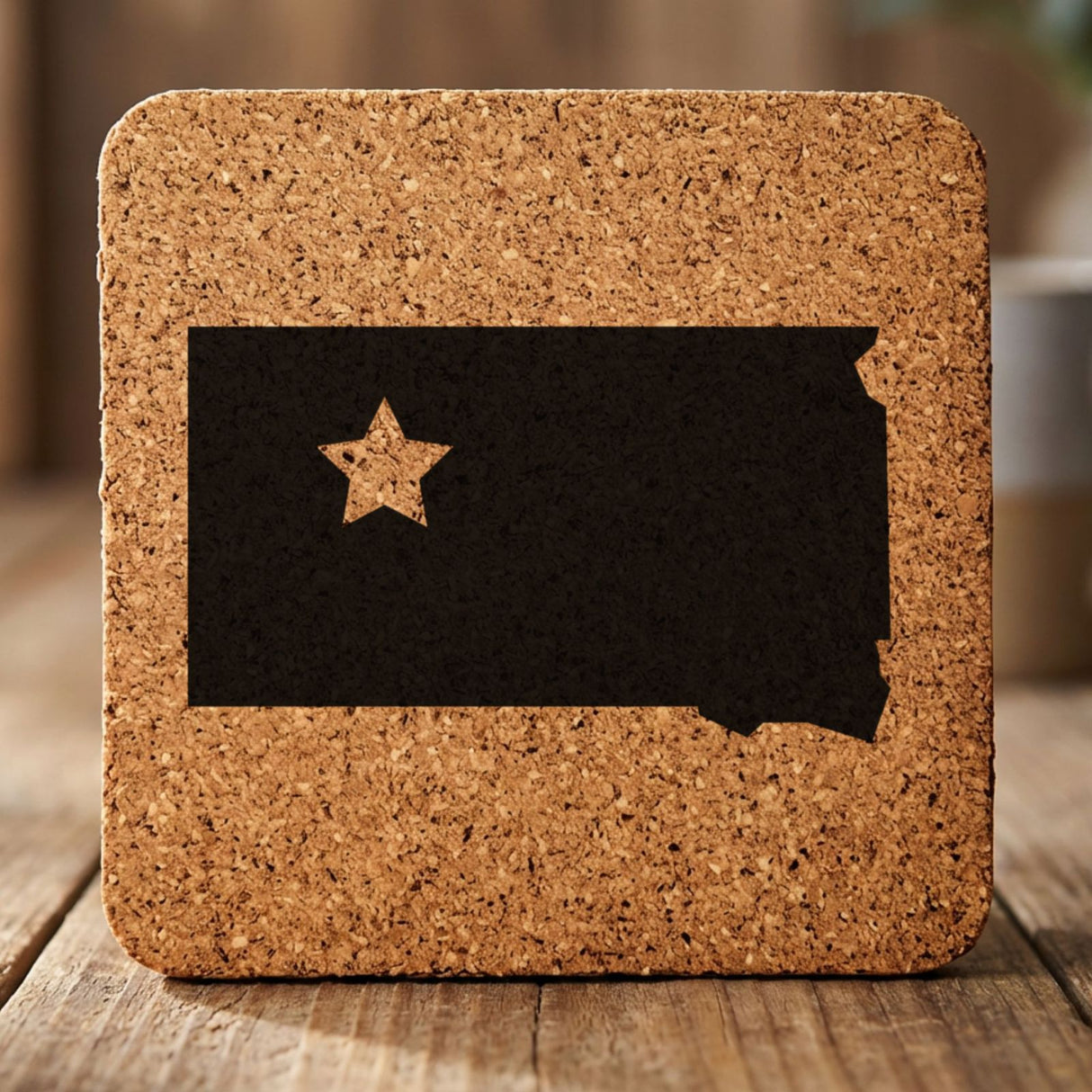 South Dakota square cork coaster engraved with the state shape and a star